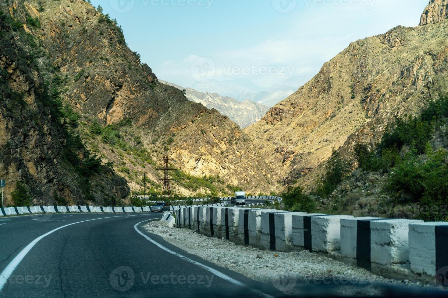 View from the car of an asphalt road in the mountainous area of Dagestan photo