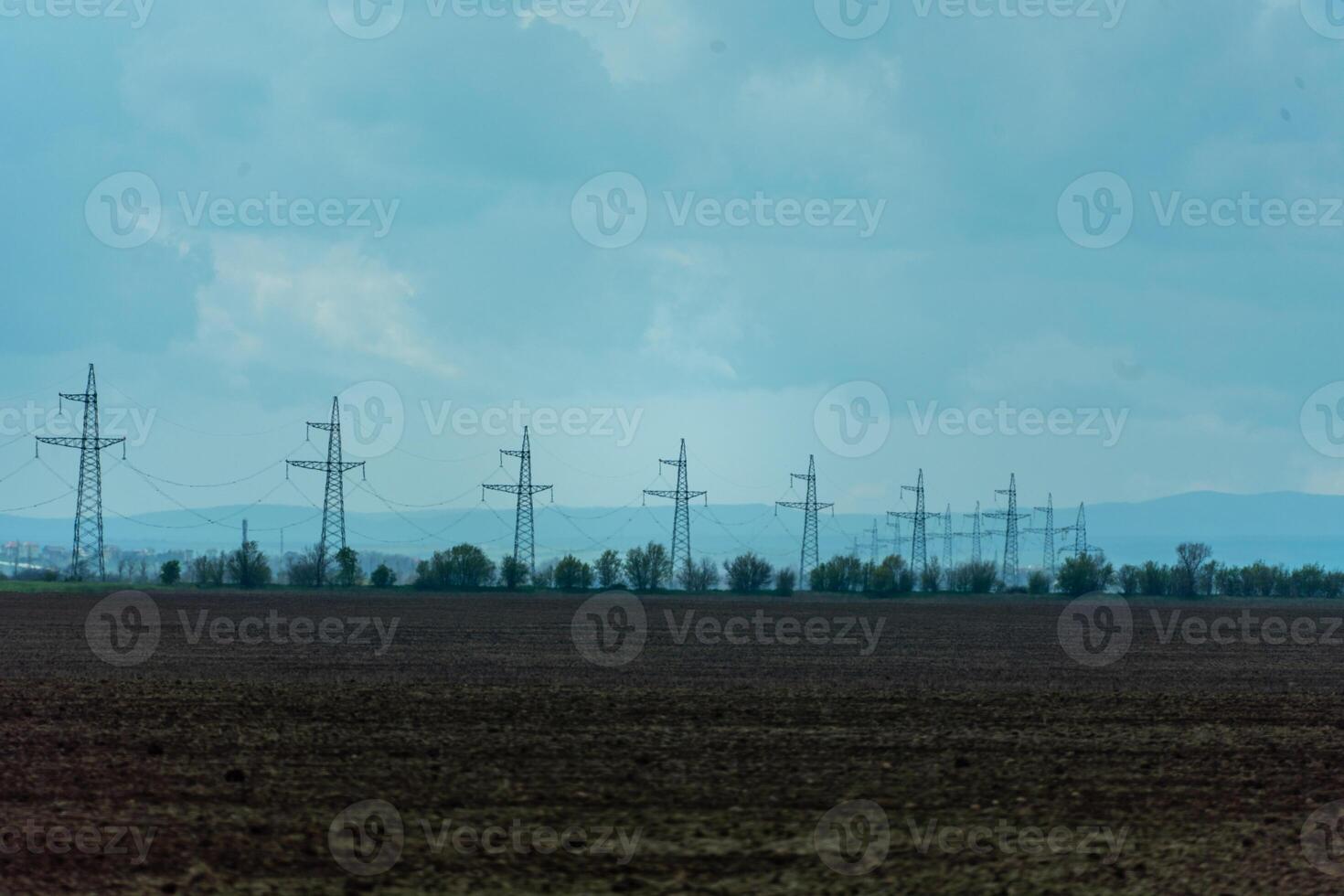 High voltage towers with sky background. Power line support with wires for electricity transmission. High voltage grid tower with wire cable at distribution station. Energy industry, energy saving photo