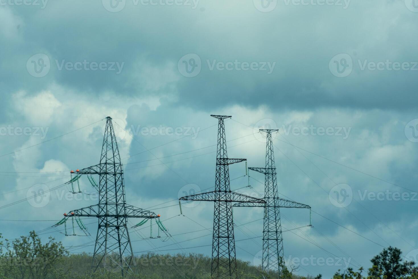 High voltage towers with sky background. Power line support with wires for electricity transmission. High voltage grid tower with wire cable at distribution station. Energy industry, energy saving photo