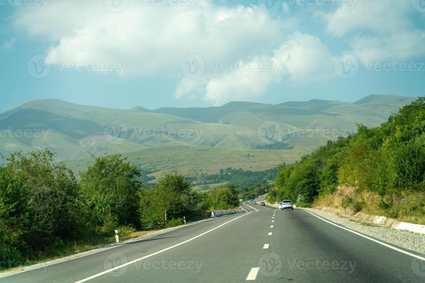 View from the car of an asphalt road in the mountainous area of Dagestan photo