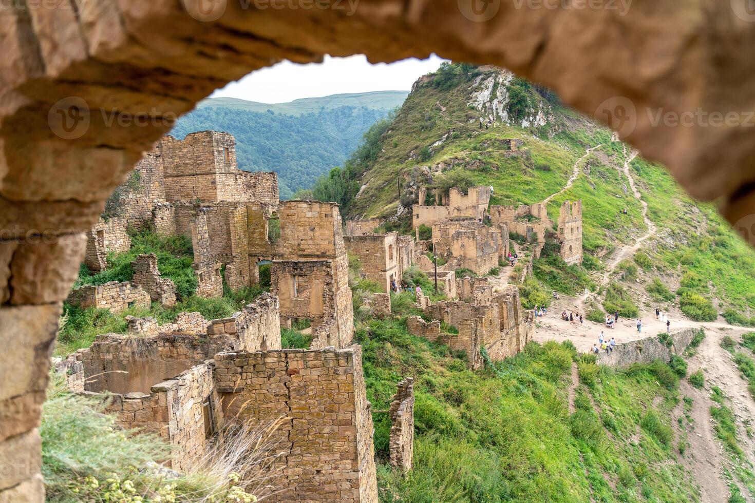 Dagestan Gamsutl. Ancient ghost town of Gamsutl old stone houses in abandoned Gamsutl mountain village in Dagestan, Abandoned etnic aul, summer landscape. photo