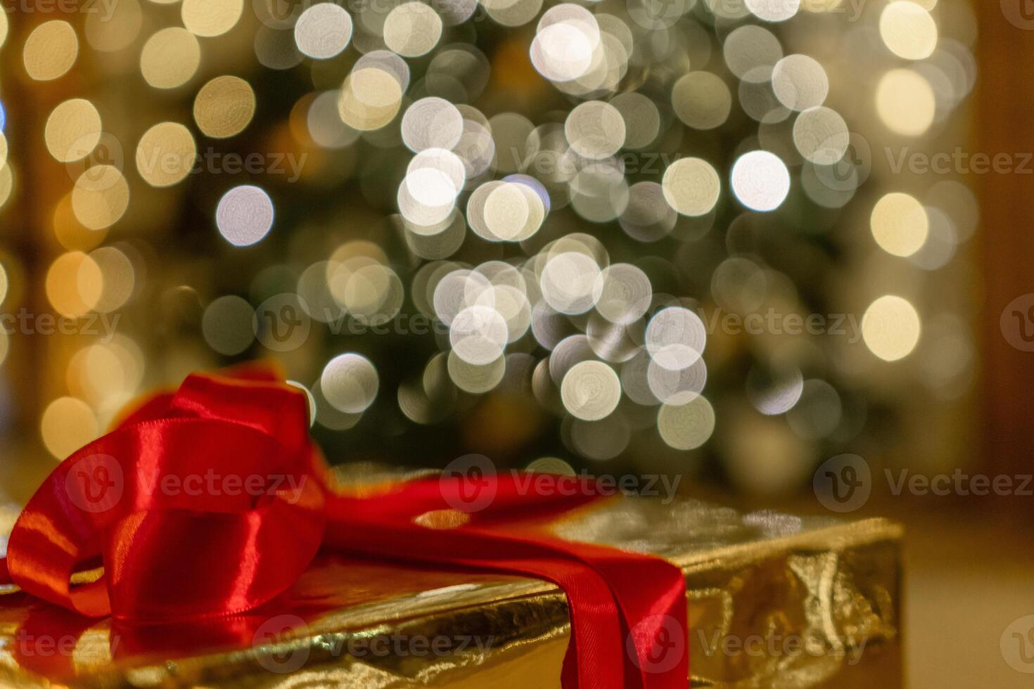Christmas gift or present box, against magic bokeh background. Beautiful Christmas gift boxes with ribbon photo