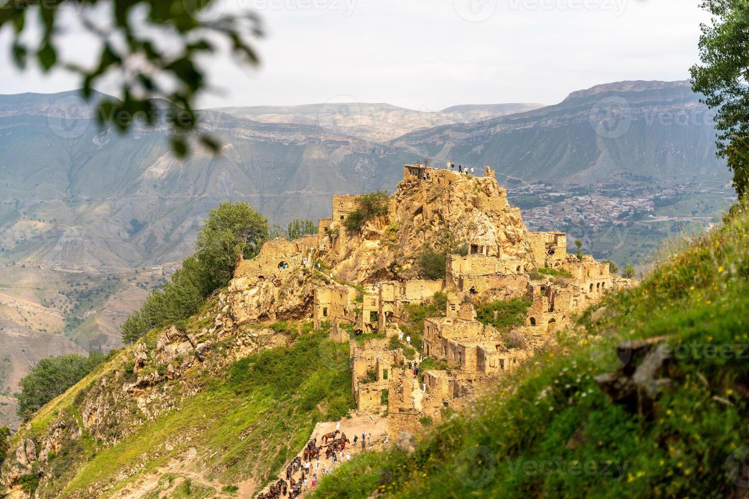 Dagestan Gamsutl. Ancient ghost town of Gamsutl old stone houses in abandoned Gamsutl mountain village in Dagestan, Abandoned etnic aul, summer landscape. photo