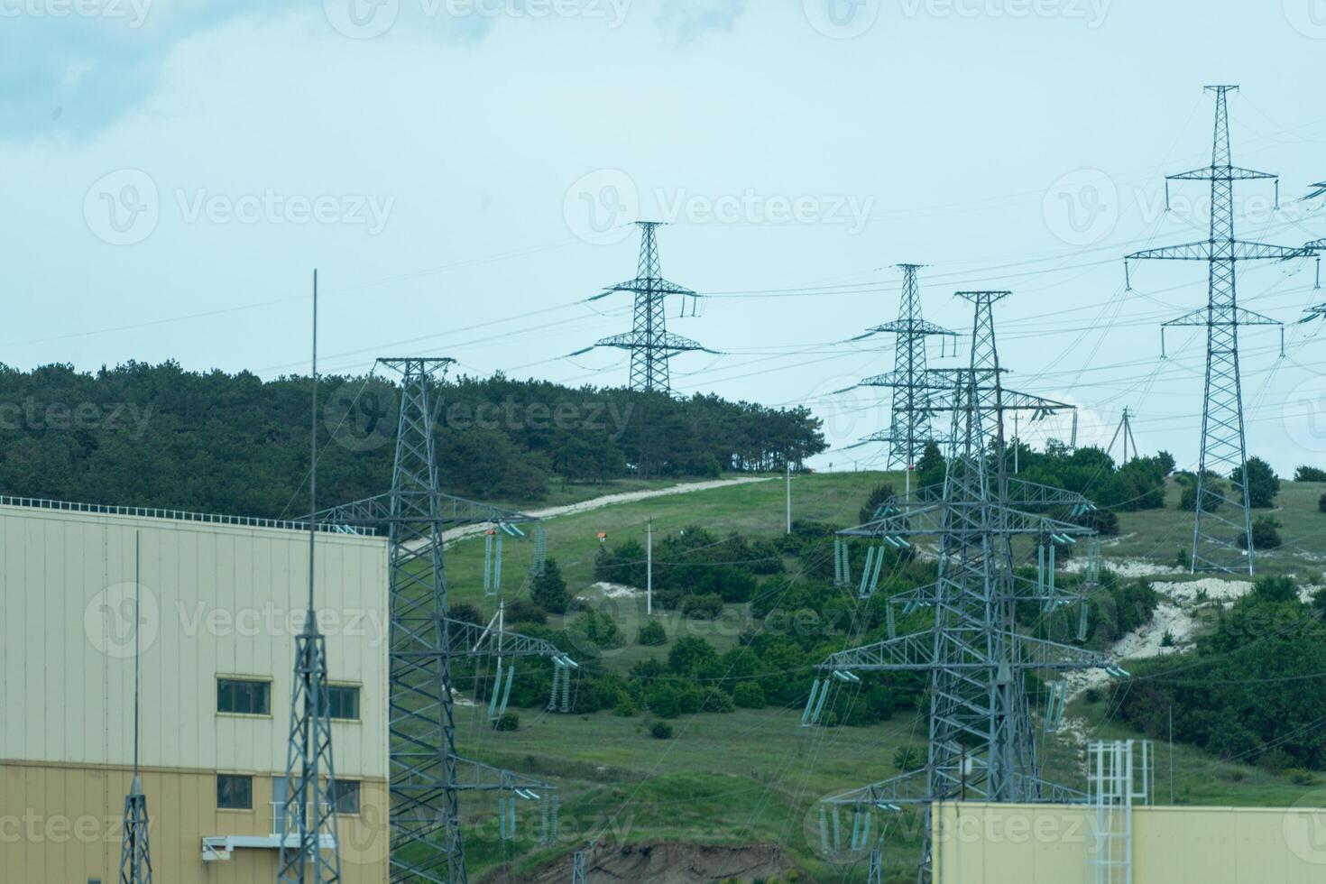 High voltage towers with sky background. Power line support with wires for electricity transmission. High voltage grid tower with wire cable at distribution station. Energy industry, energy saving photo