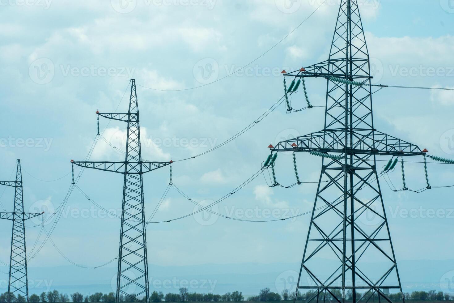 High voltage towers with sky background. Power line support with wires for electricity transmission. High voltage grid tower with wire cable at distribution station. Energy industry, energy saving photo