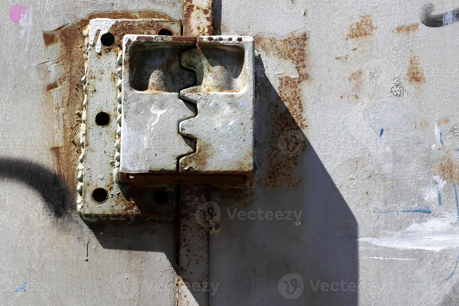 An old metal lock hangs on the fence. photo
