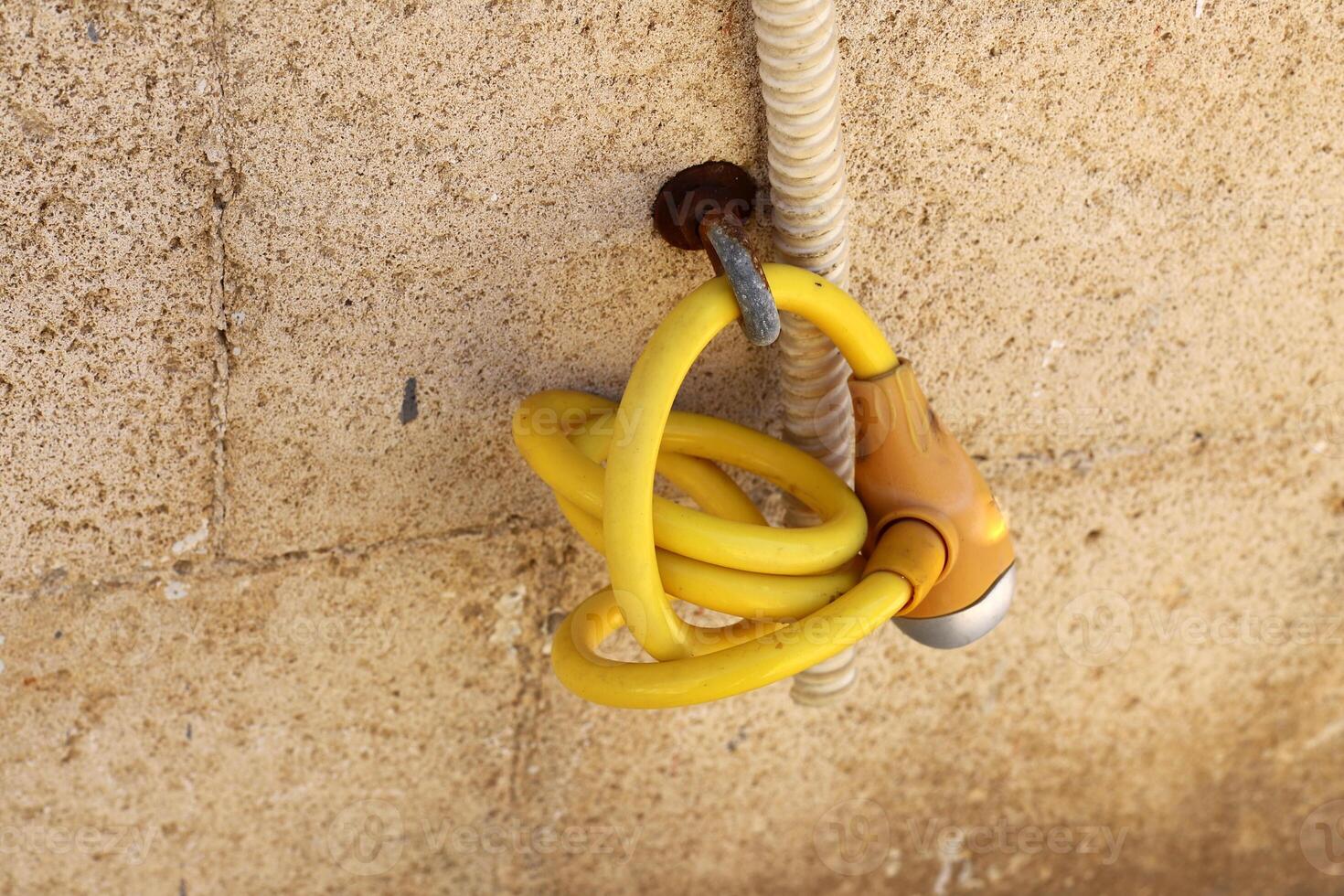 An old metal lock hangs on the fence. photo