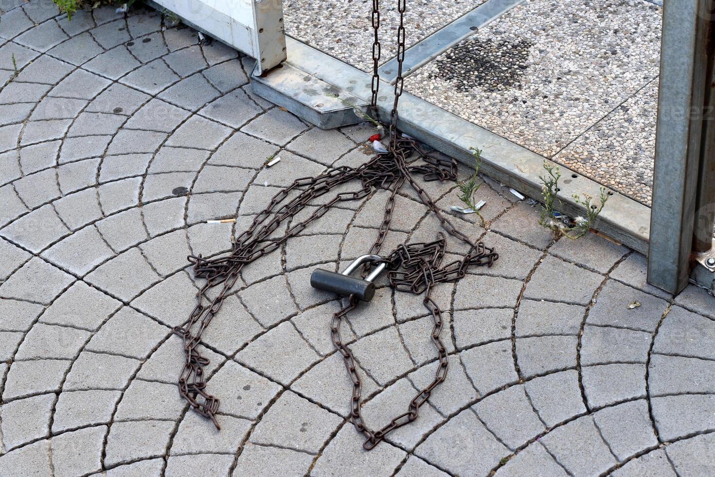 An old metal lock hangs on the fence. photo