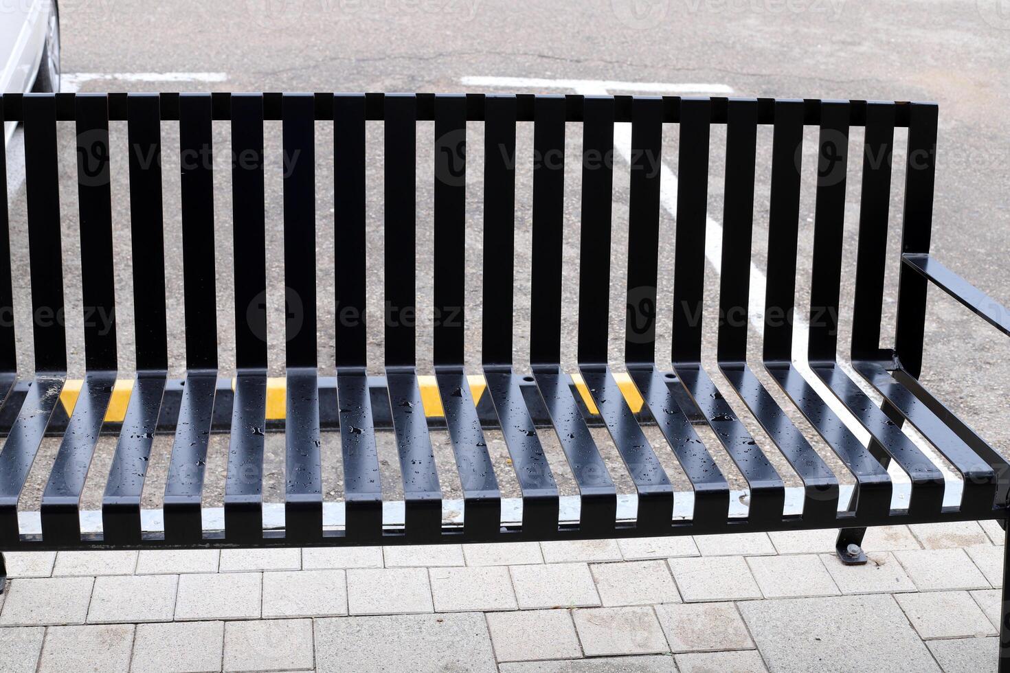 A bench for relaxing in a city park on the seashore. photo
