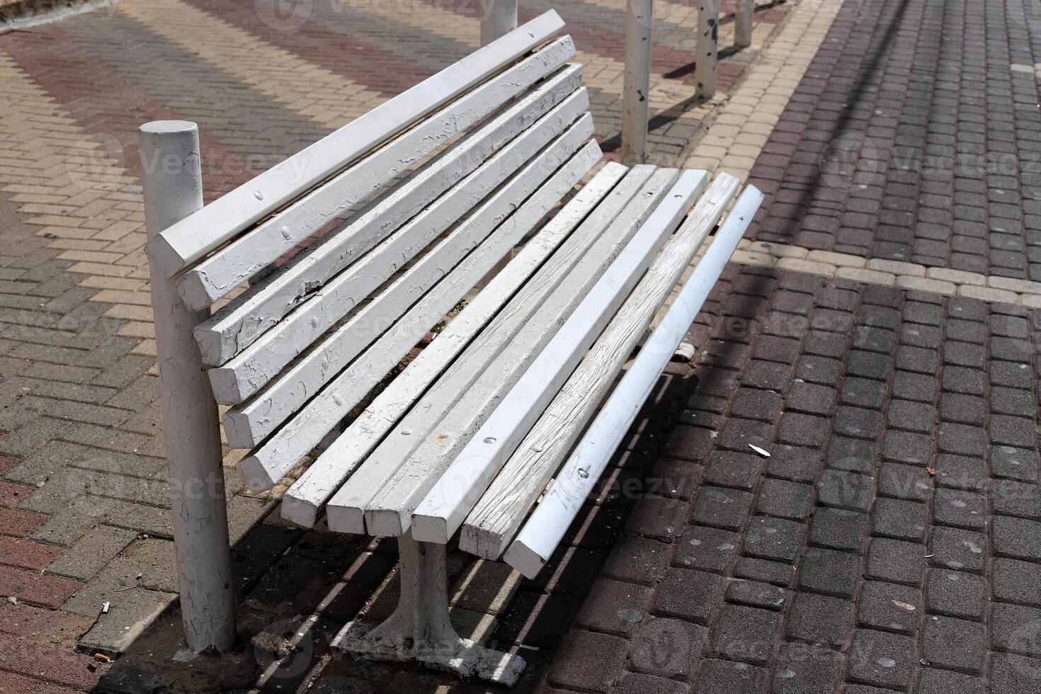 A bench for relaxing in a city park on the seashore. photo