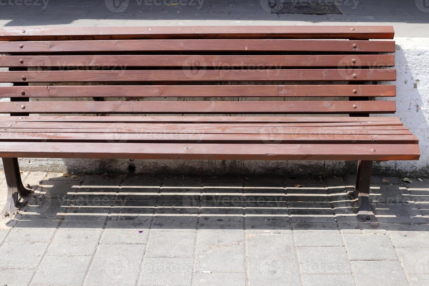 A bench for relaxing in a city park on the seashore. photo