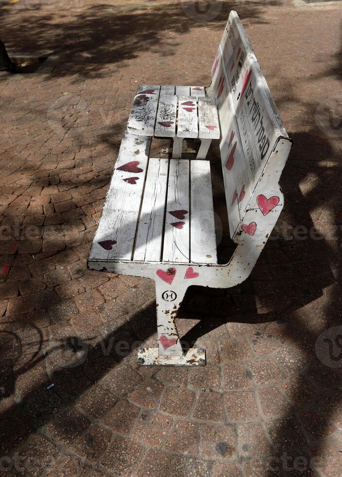 A bench for relaxing in a city park on the seashore. photo
