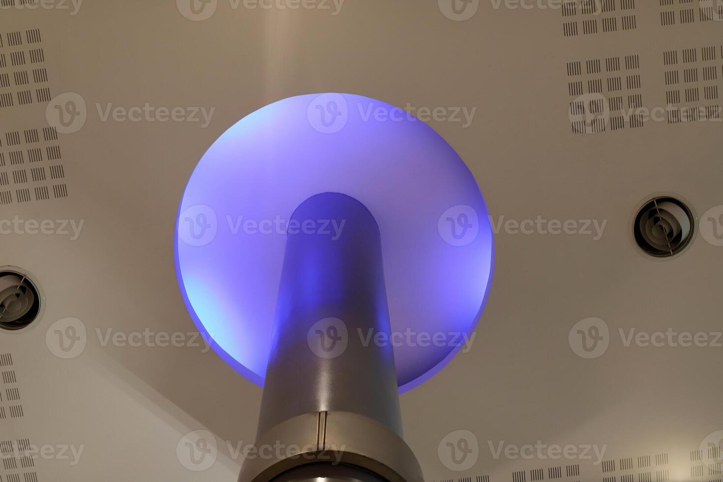 A lamp for illuminating the interior of the room hangs on the ceiling. photo