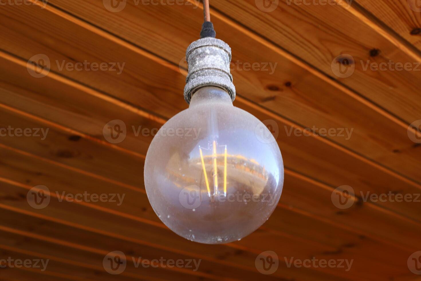A lamp for illuminating the interior of the room hangs on the ceiling. photo