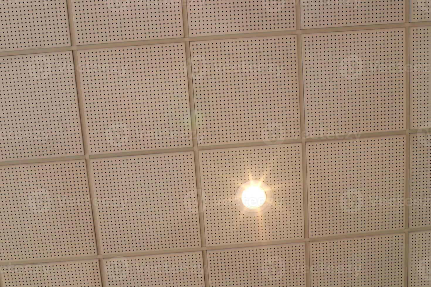 A lamp for illuminating the interior of the room hangs on the ceiling. photo