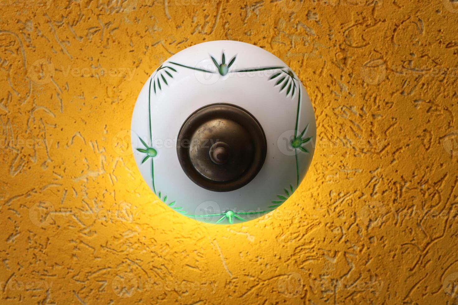 A lamp for illuminating the interior of the room hangs on the ceiling. photo
