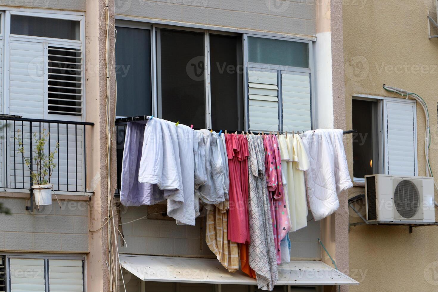 Washed laundry hangs on a rope outside the window. photo