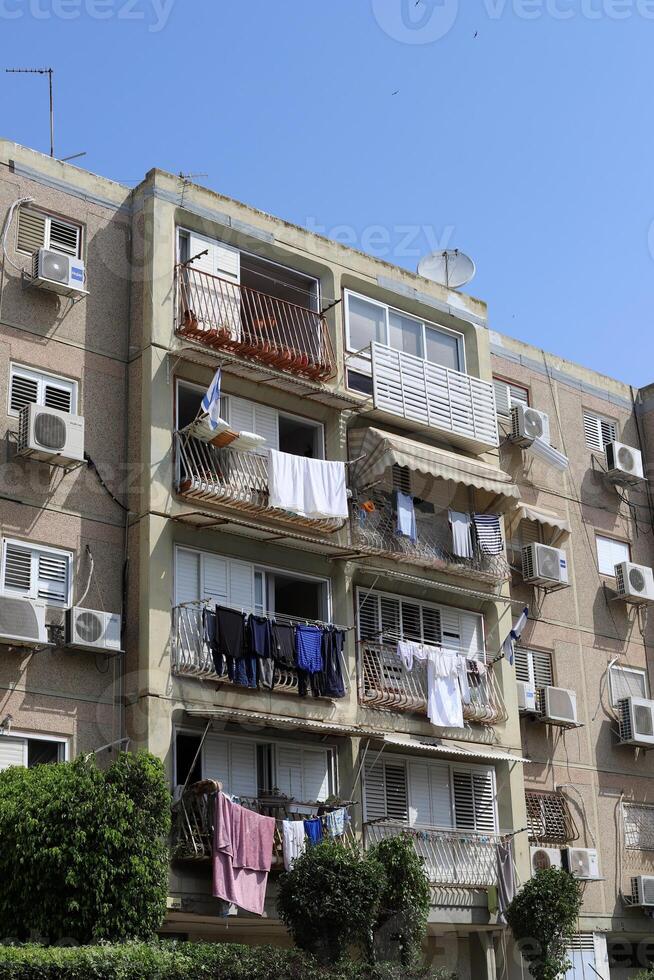 Washed laundry hangs on a rope outside the window. photo