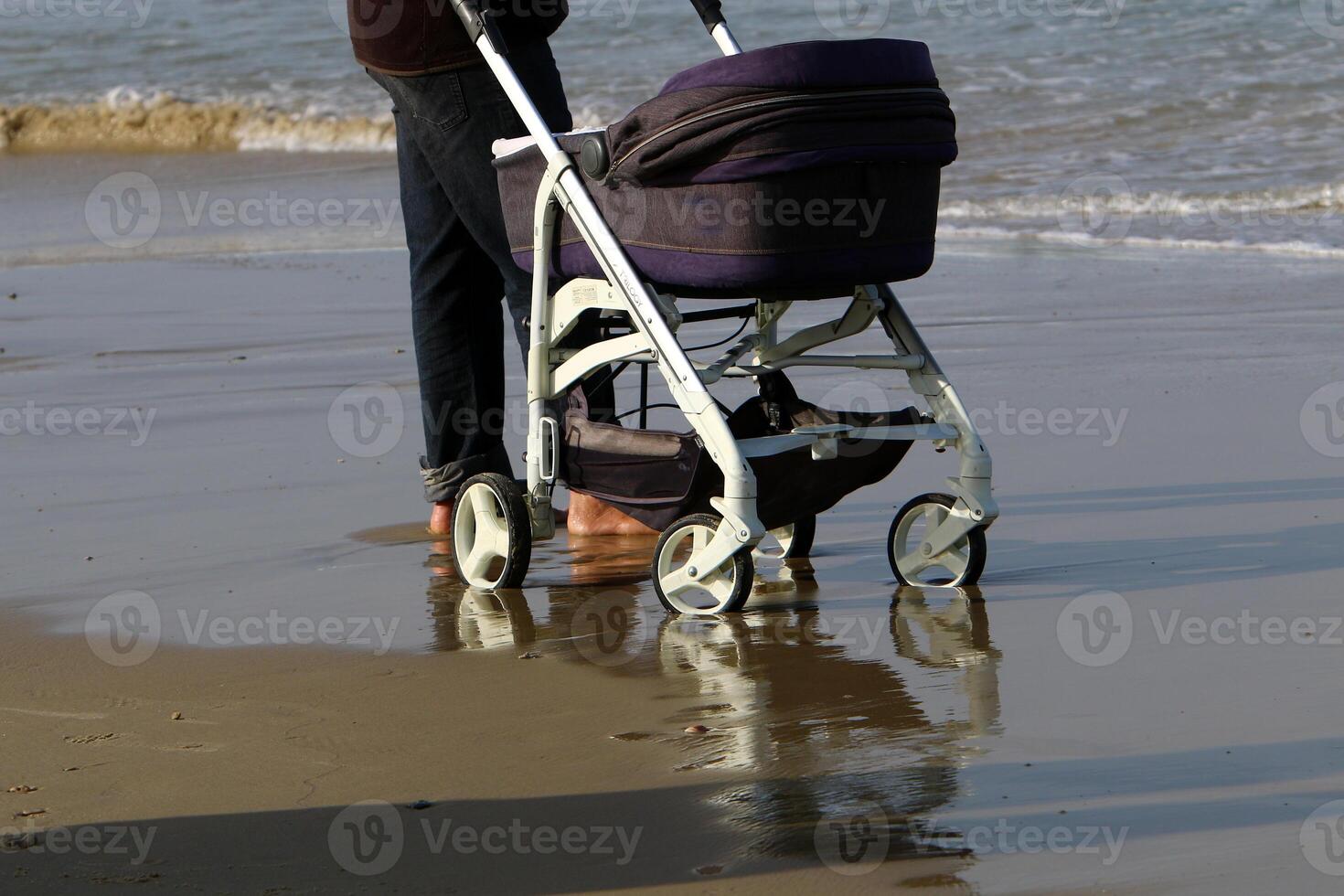 An athlete walks barefoot on the sand on the seashore. photo