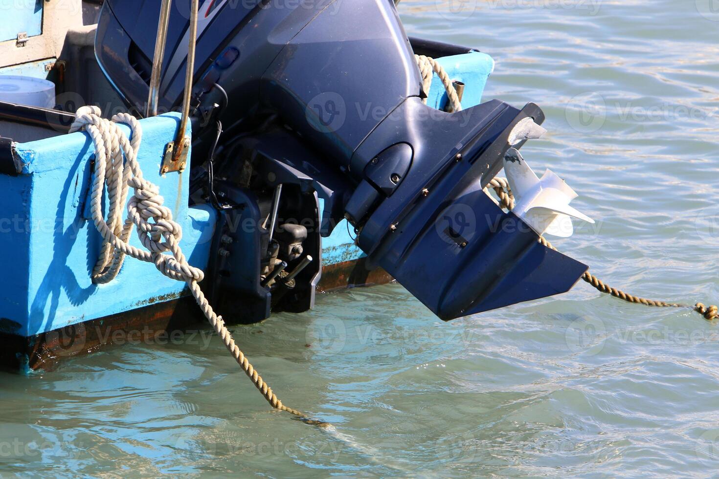 The propeller of a motor boat at the pier in the seaport. photo