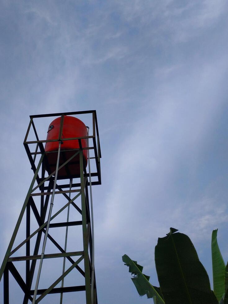 water tower, water tank concrete tower with the sky on background. photo