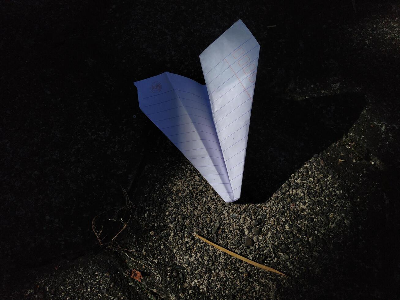 paper airplane on the paving floor, text space photo