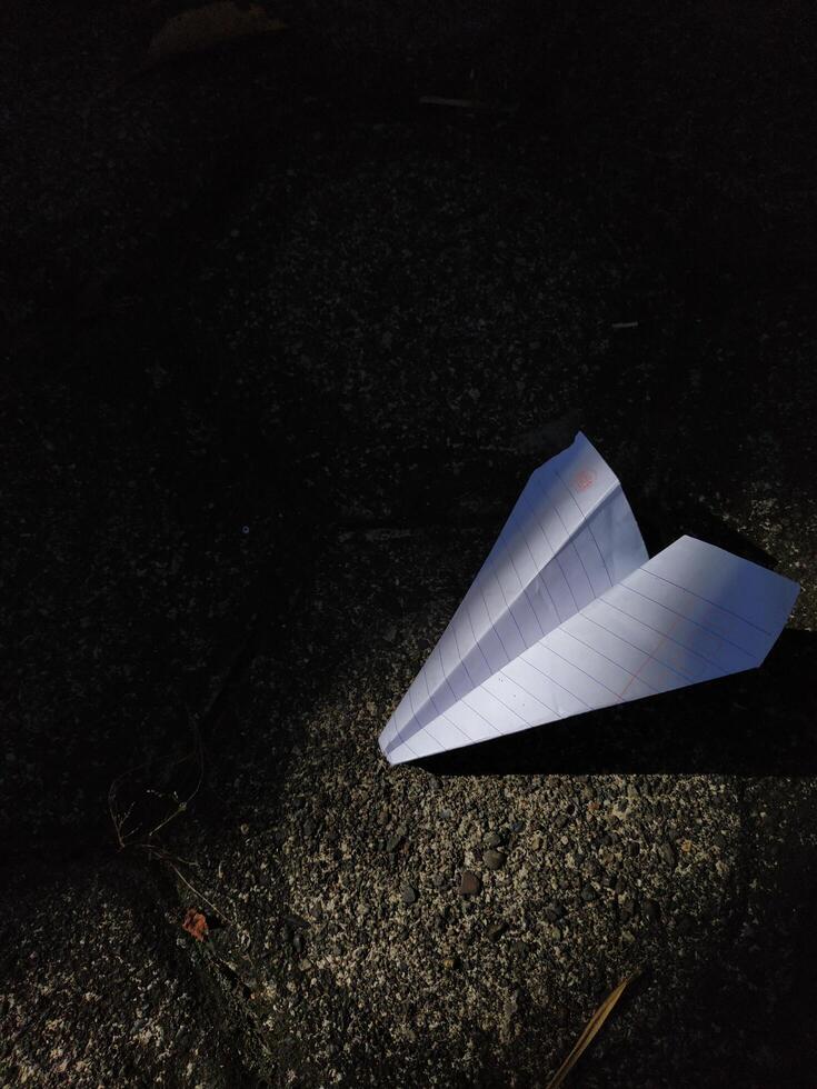 paper airplane on the paving floor, text space photo
