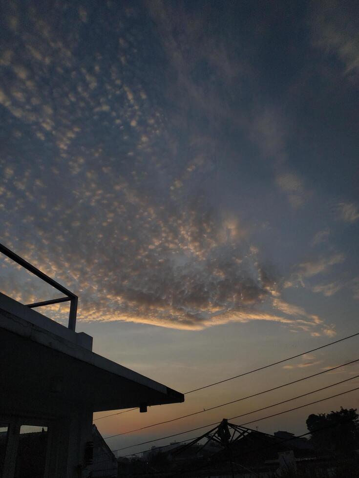 dramatic morning sky or Sunset sky for background seen from above the house photo
