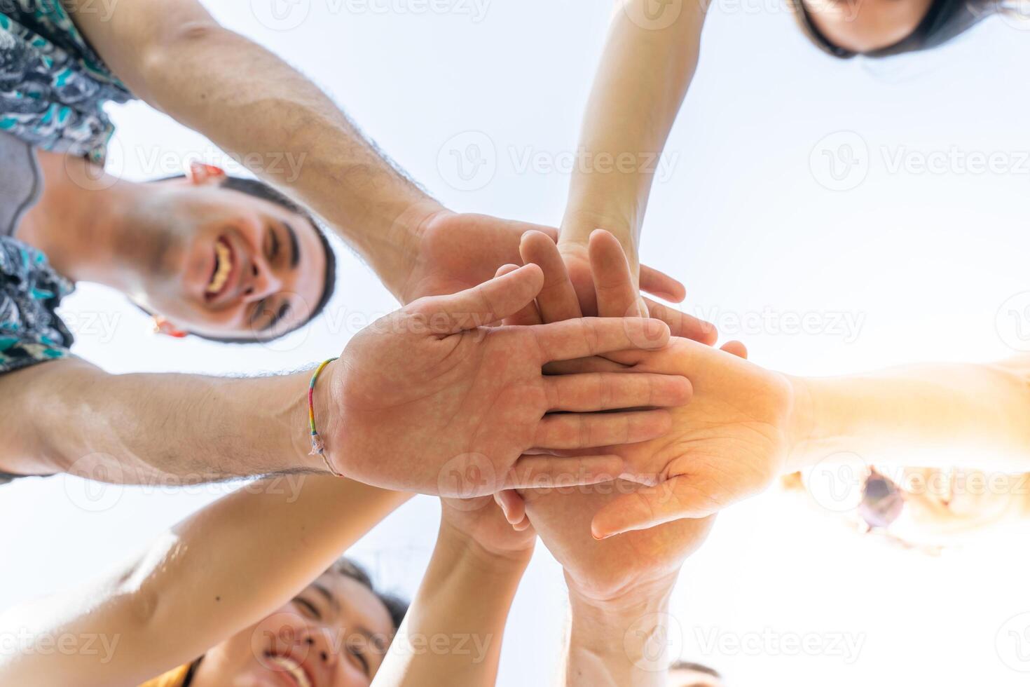 Teamwork, unity concept, group of friends put their hands together. photo
