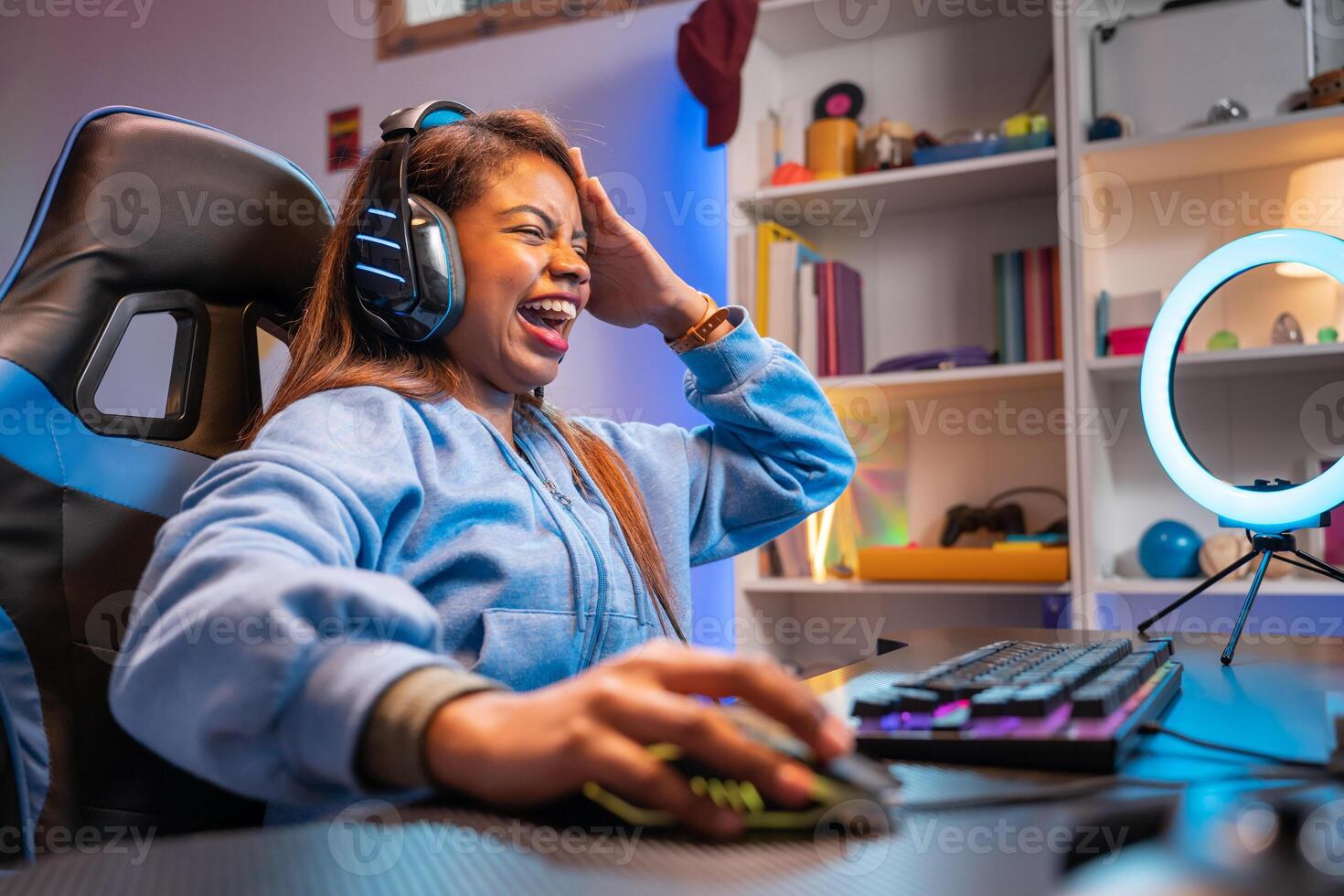 Happy latin woman gamer playing game streaming online with microphone and headphones photo