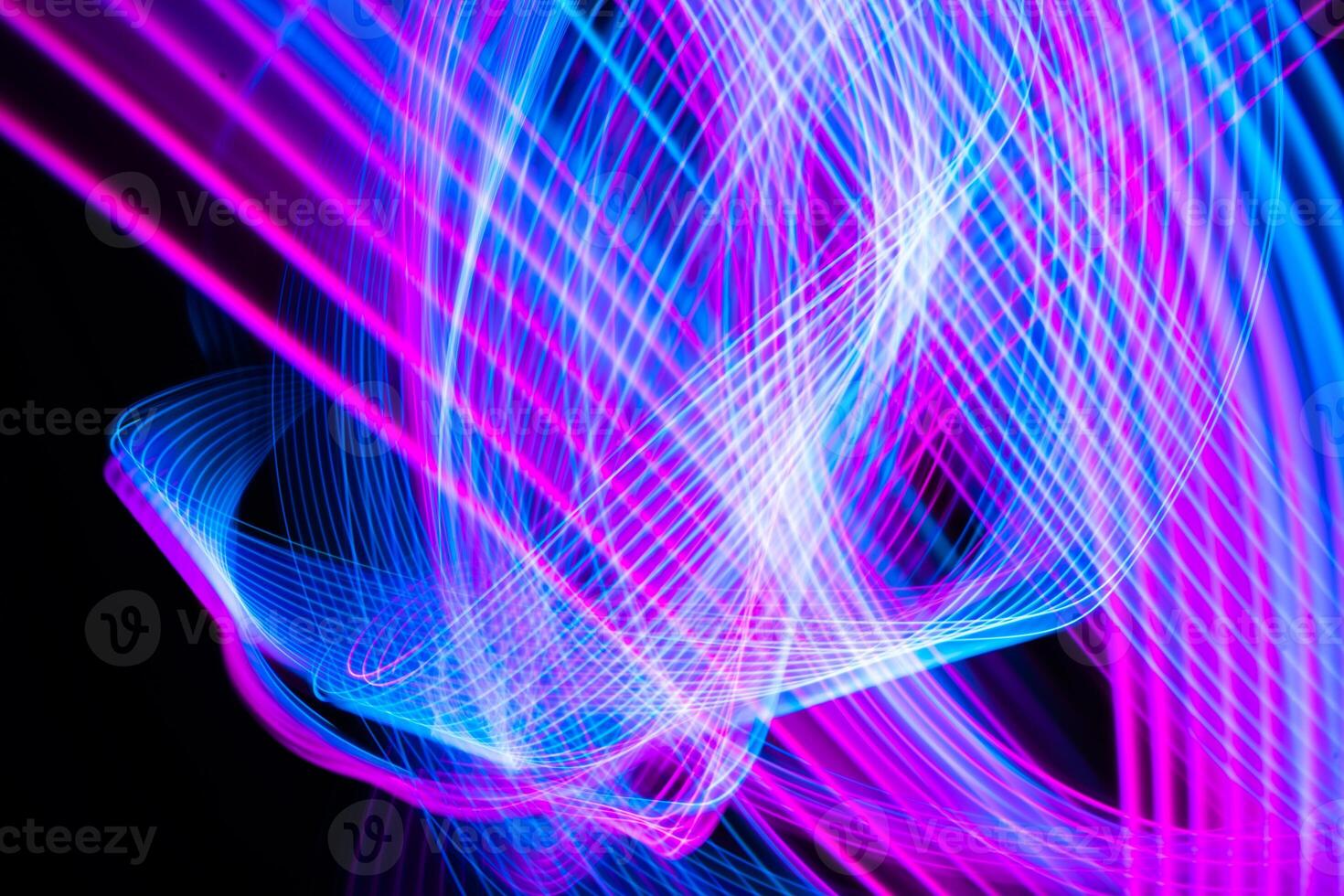 Abstract technology background of long exposure light. Blue and pink on black. photo