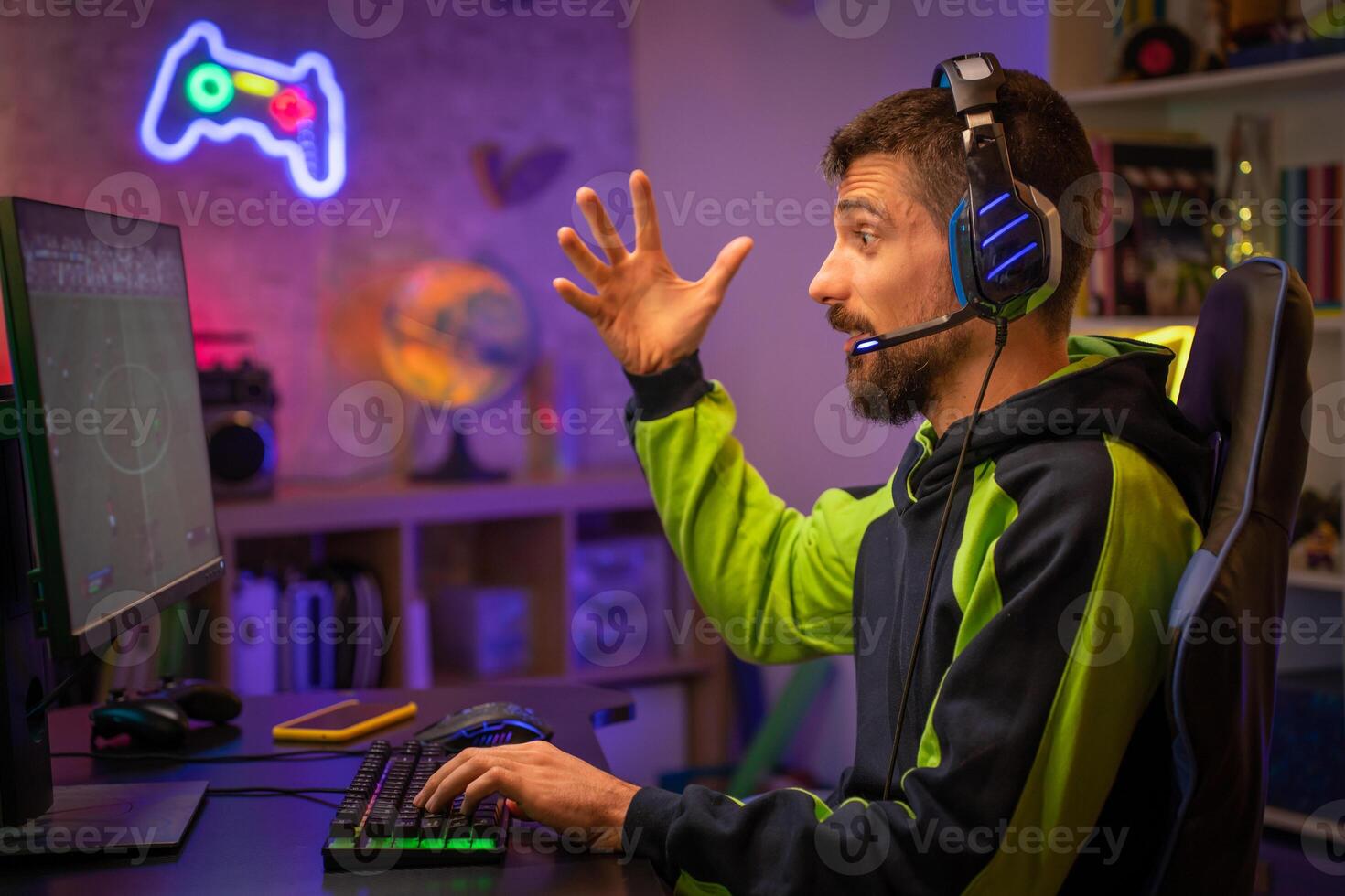 Gamer Playing Online Game on Computer with Colorful Neon Led Lights. photo
