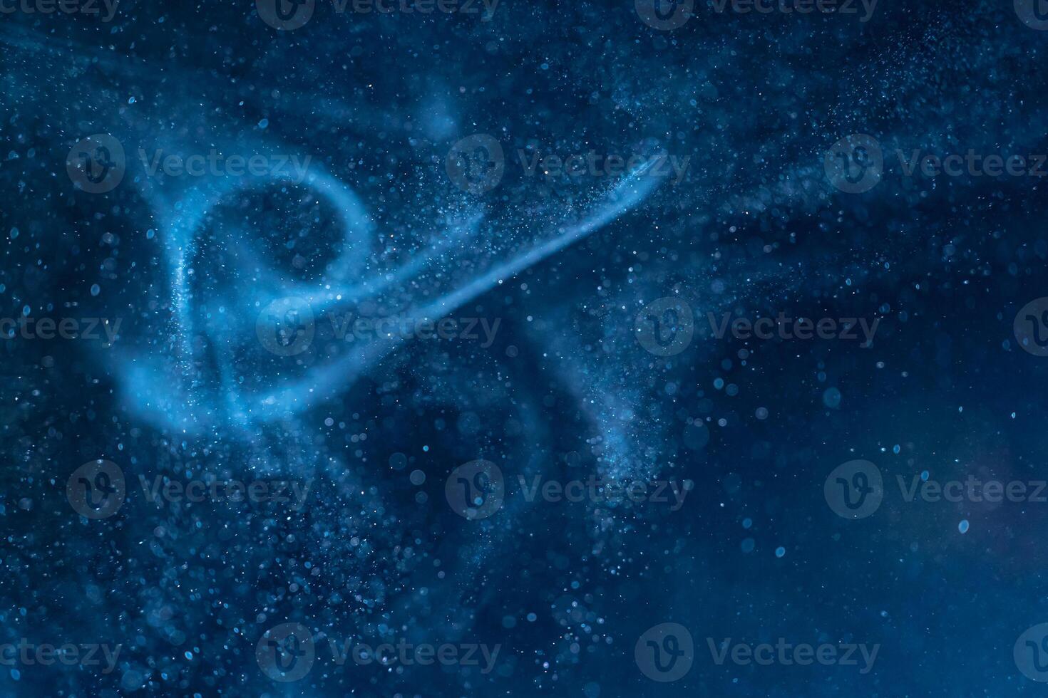 Dust blue particles on black background. Glittering sparkling bokeh overlay with copy space for text. photo