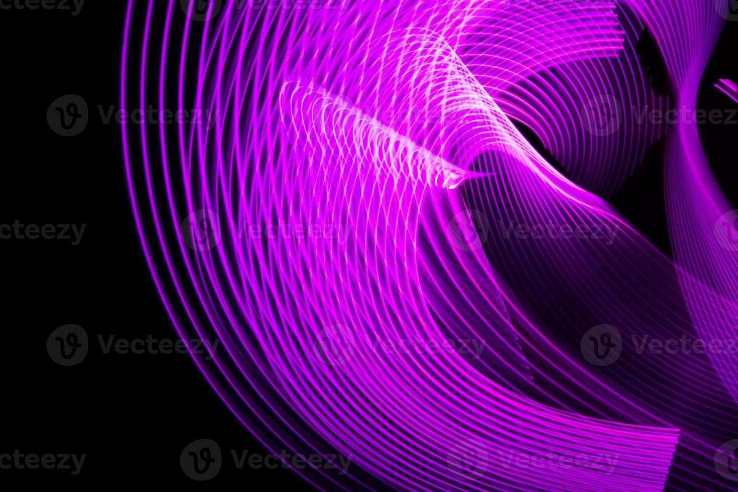 Abstract neon metallic purple curvy lines on black background. photo