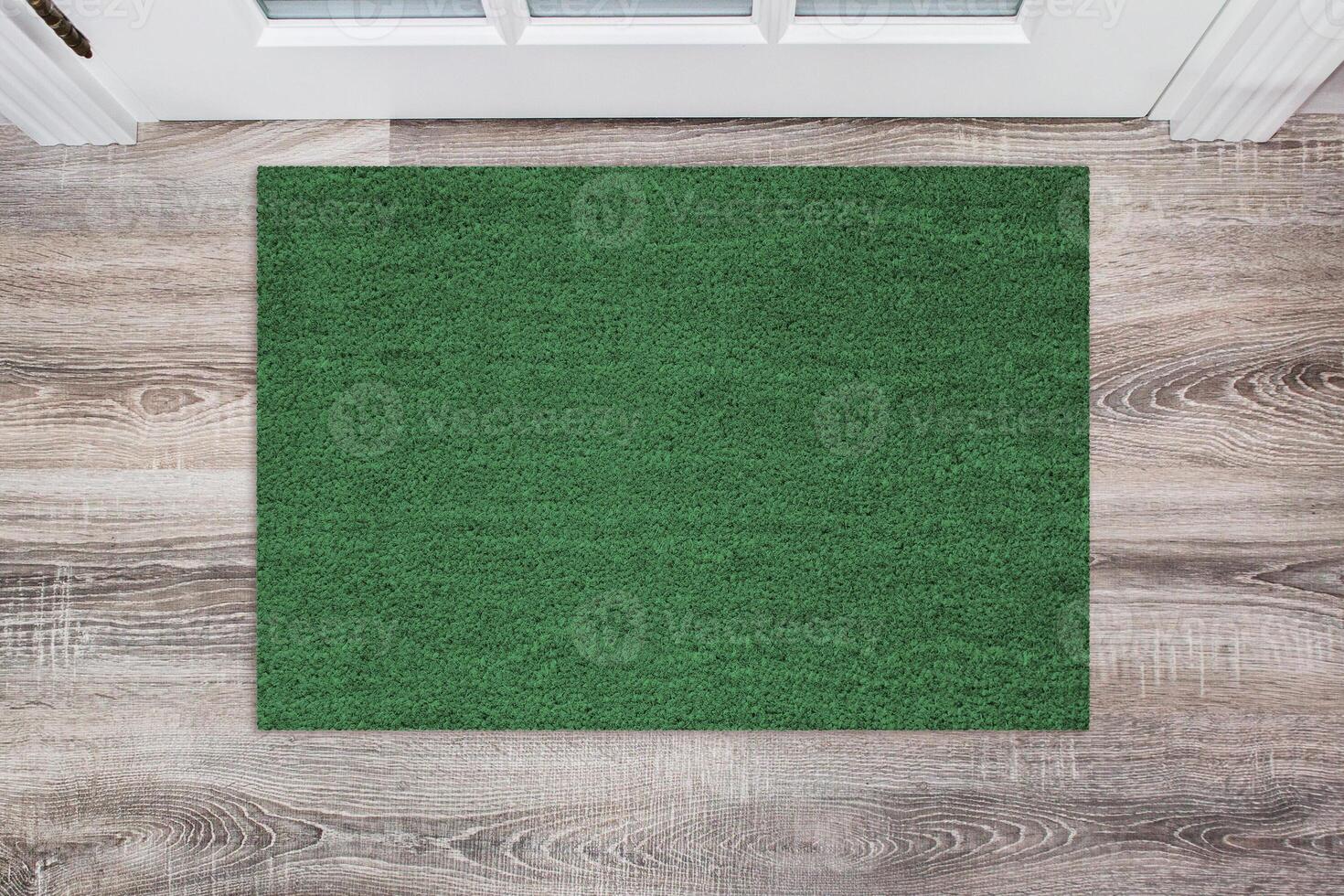 Green Coir Doormat on a wooden floor in front of the door. Product mockup photo