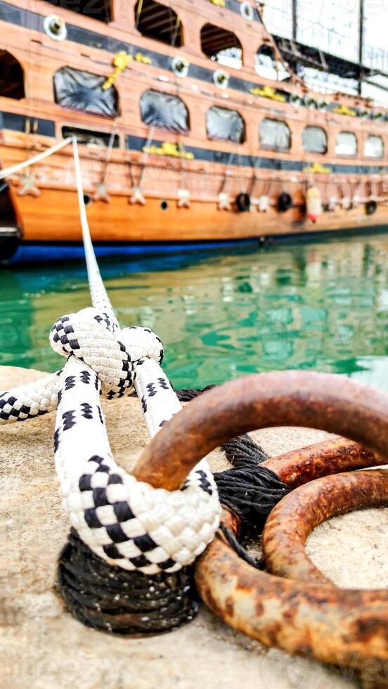 Symbol of Safety, Large Old Ship Moored at Dock with Mooring Knot, Close-Up. photo