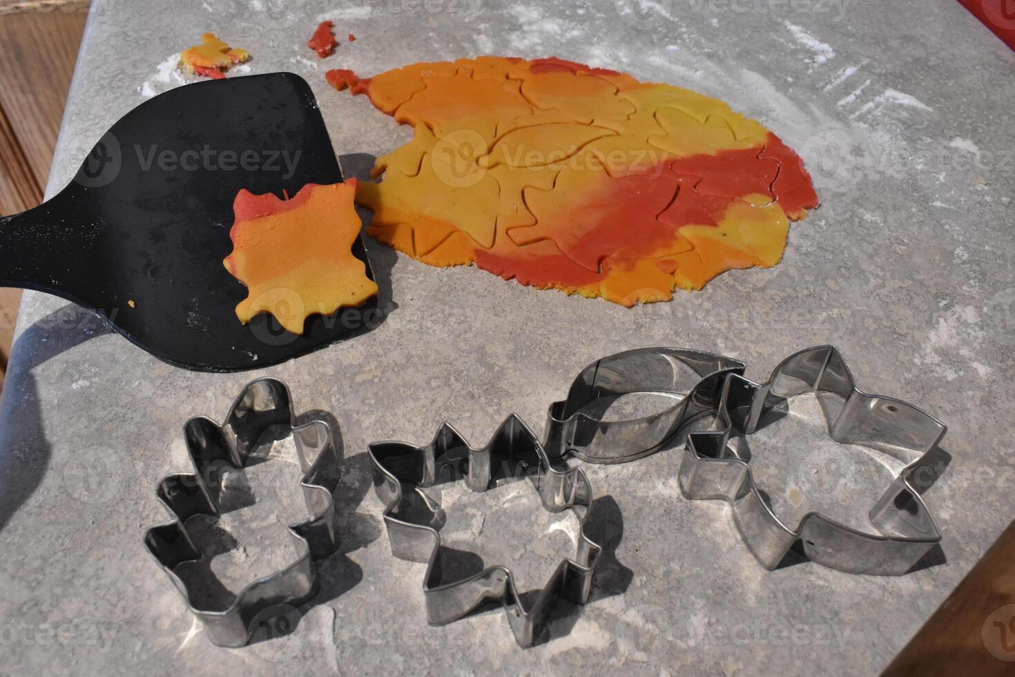 Cookie Cutters Shaped like Leaves and Dough for Fall Leaf Cookies photo
