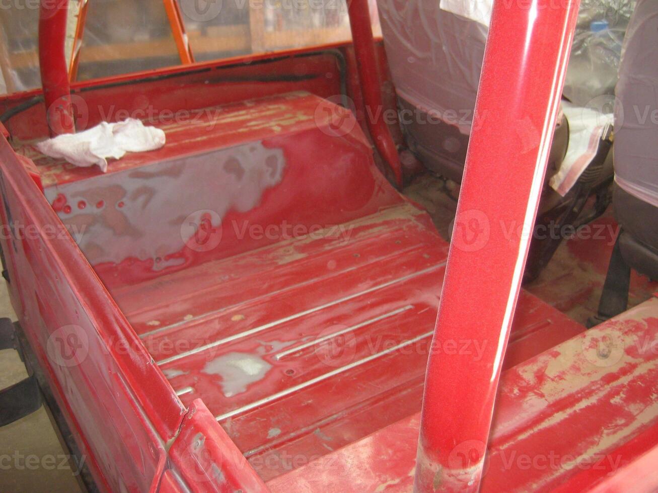 Auto Body Repair and Repainting Prep Work on Red Vehicle photo