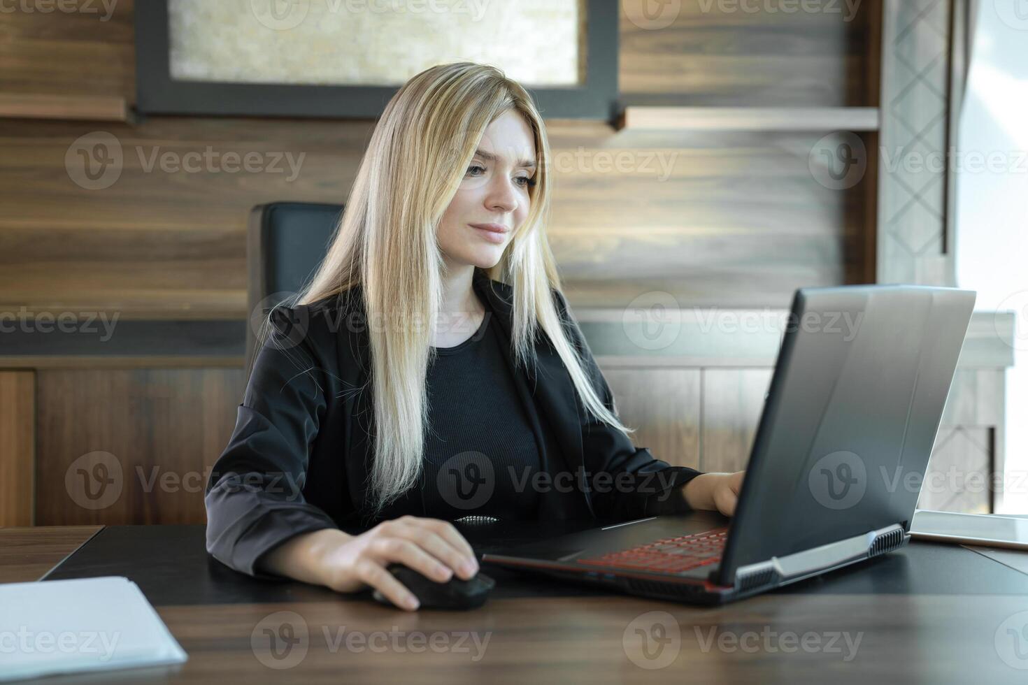 Young teacher is sitting in front of laptop conducting lesson, concept of online teaching. photo