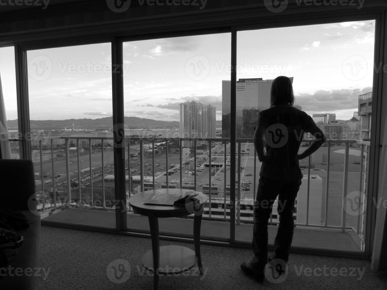 Woman Looking out Full Length Window in Las Vegas photo