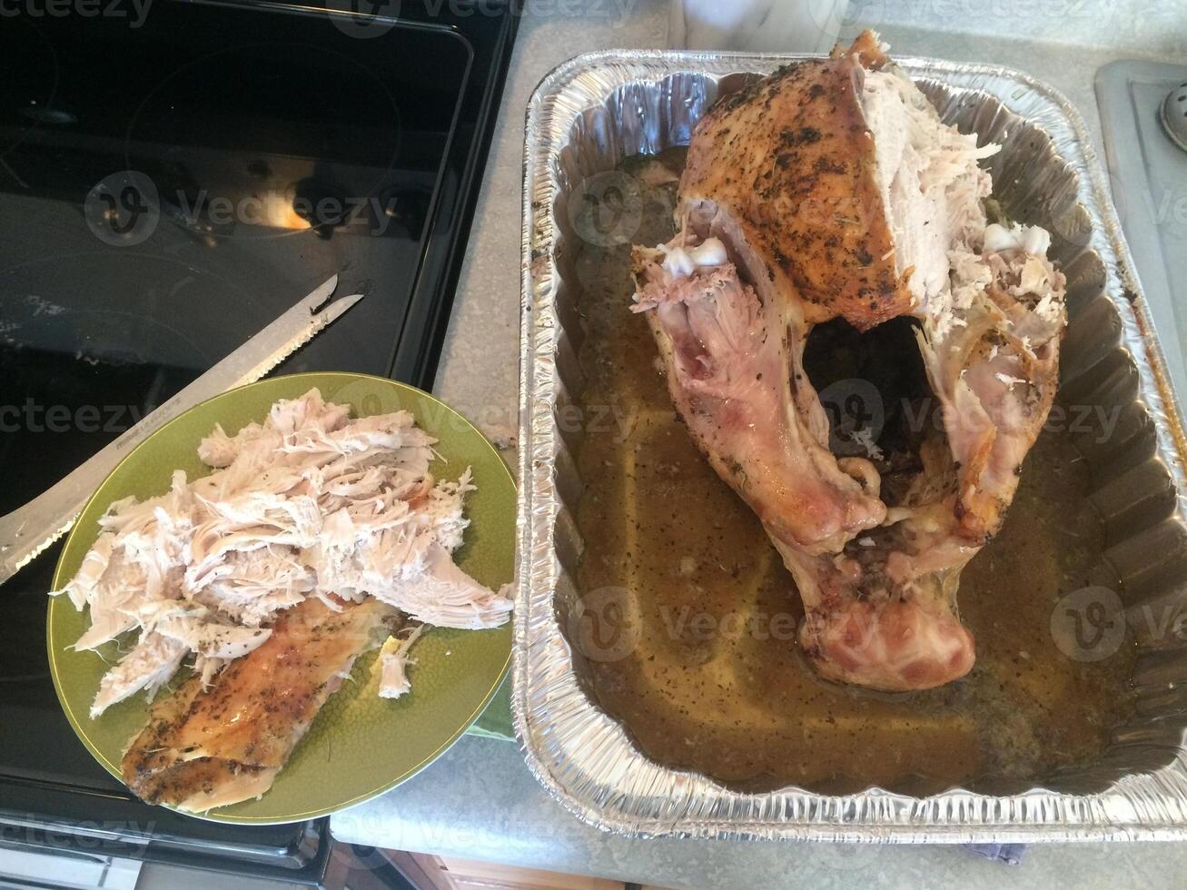 Carving Fresh Roasted Turkey in Tray, Traditional Home Cooking photo