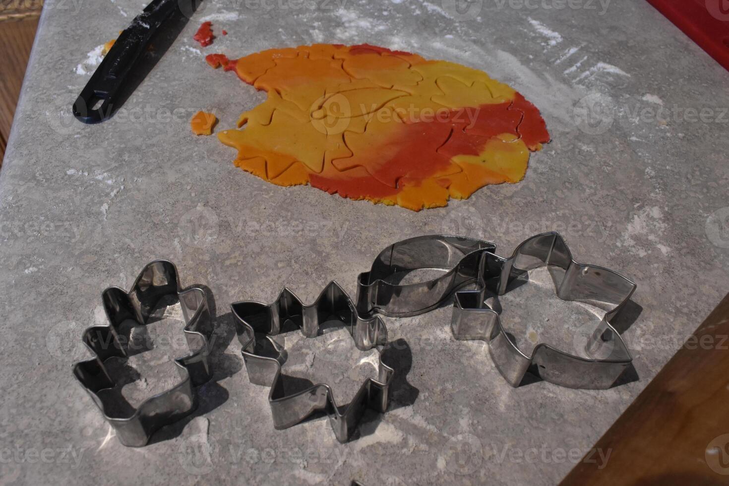 4 Cookie Cutters Shaped like Leaves and Dough for Fall Leaf Cookies photo
