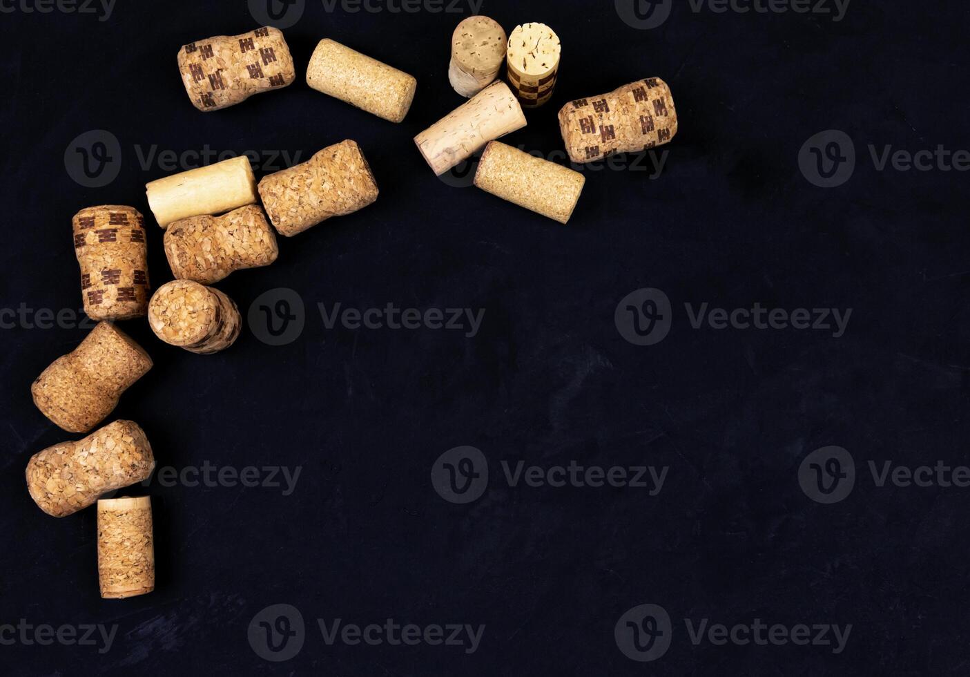 wine corks on a black textured surface. top view. place for text photo