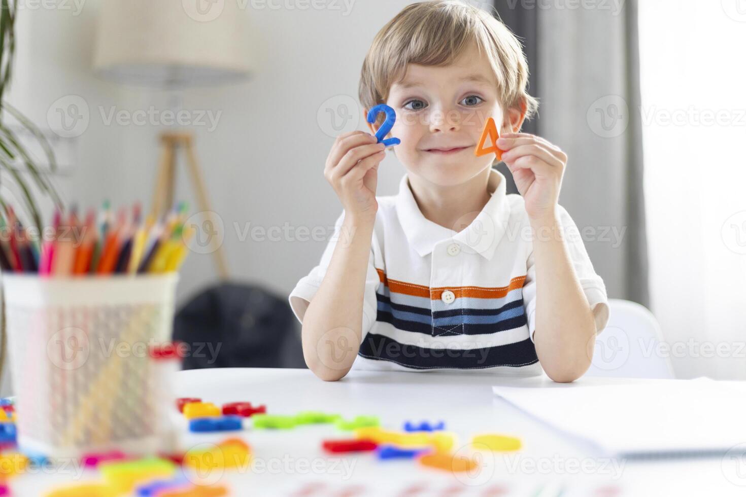 Young Boy Learning Shapes During Homeschooling Session photo