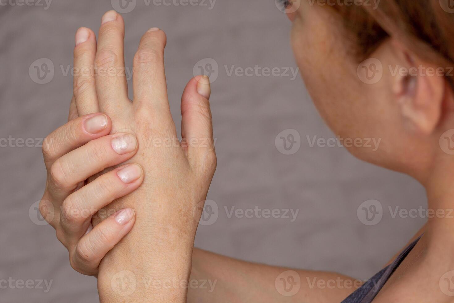 Woman hands showing numb hand over cropped body photo