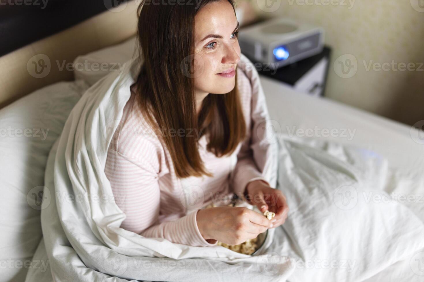 Woman Eating Breakfast in Bed Contentedly photo
