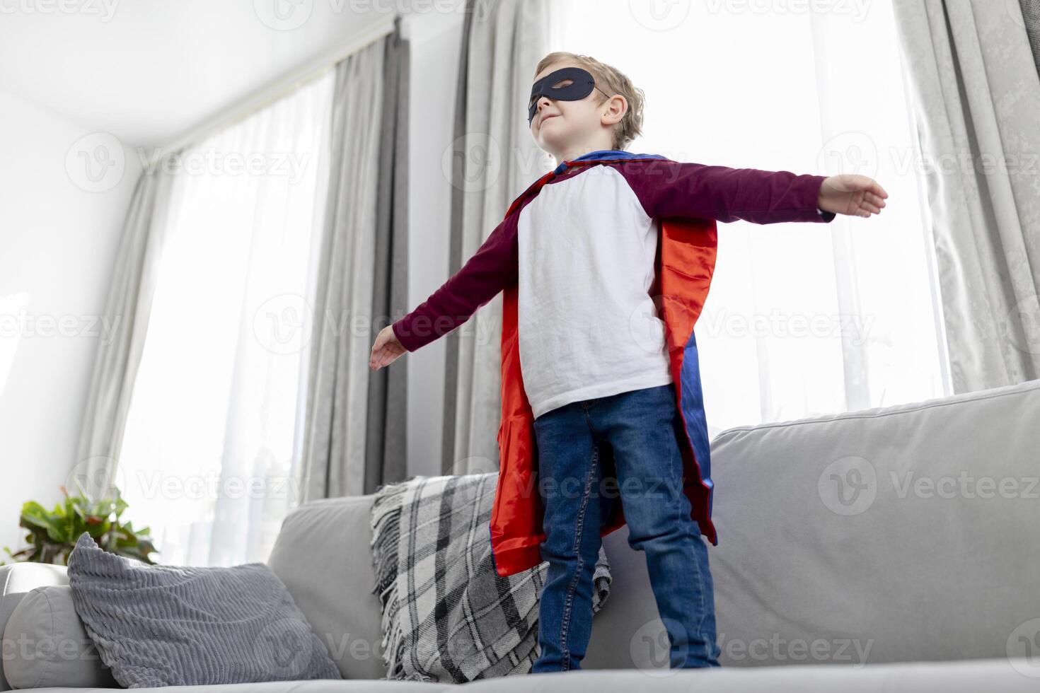 Child in Superhero Costume Playing at Home photo