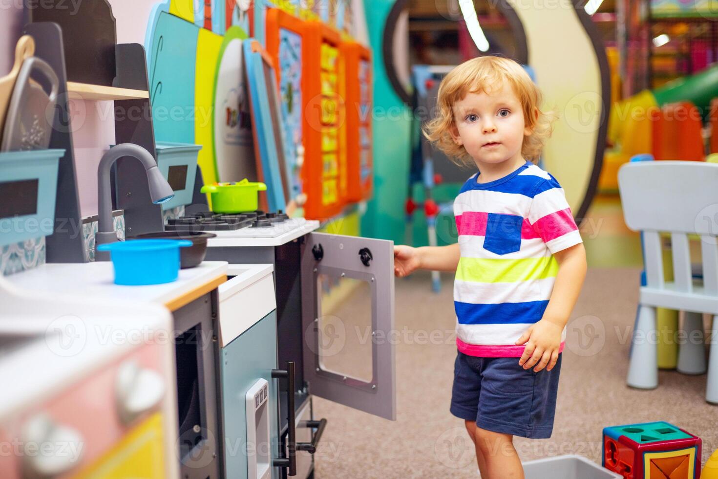 Child playing with colorful toys at the learning center or in kindergarten photo