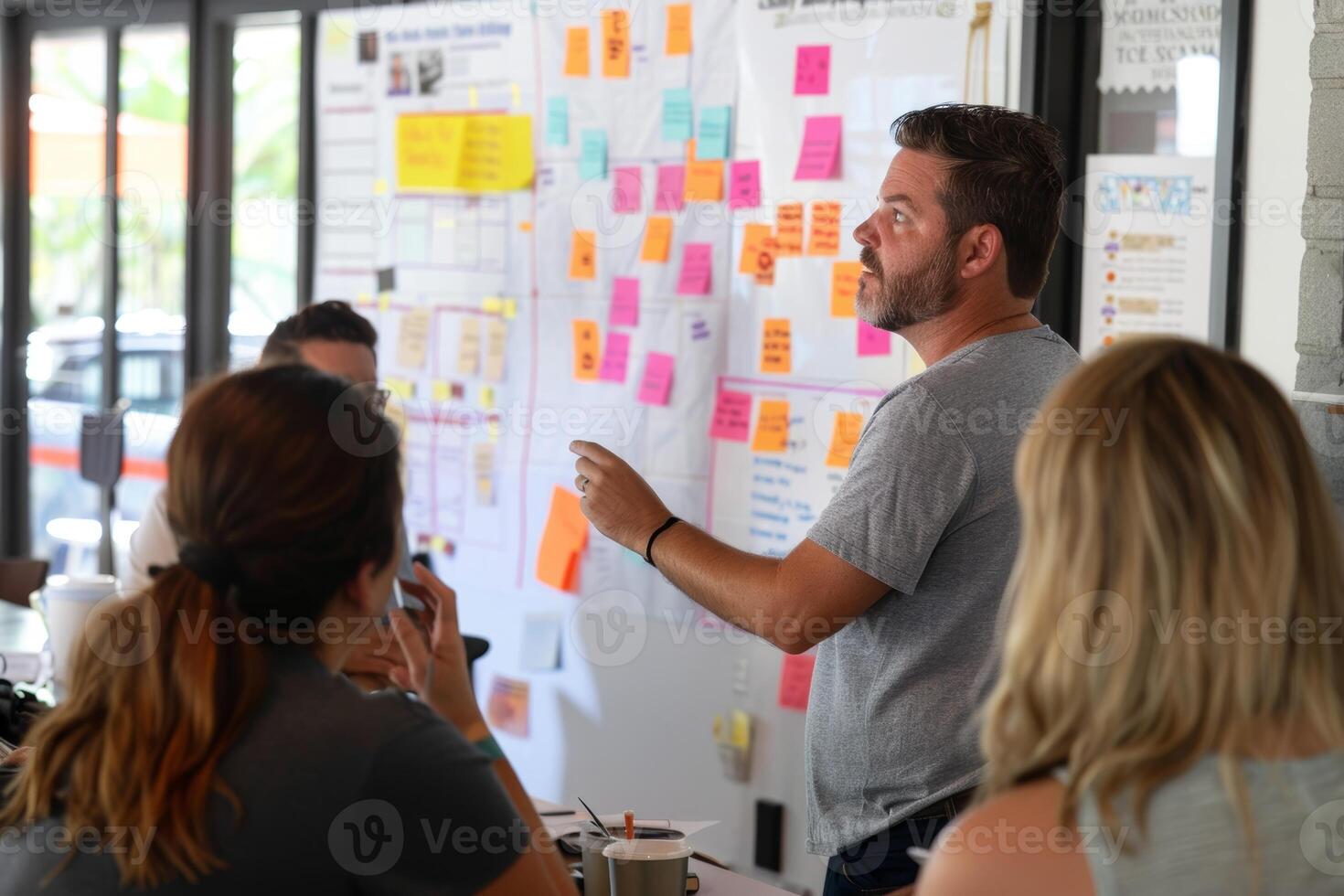 Project Manager Leading Kickoff Meeting with Diverse Team Discussing Goals and Timelines photo