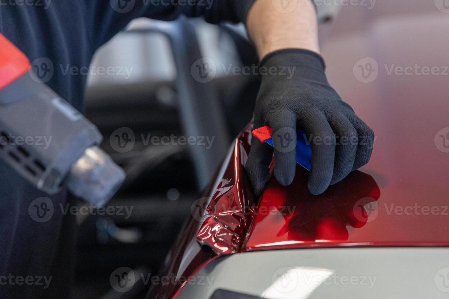 Wrapping a new foil to a car by heat gun, gluing a new foil, detailing concept photo